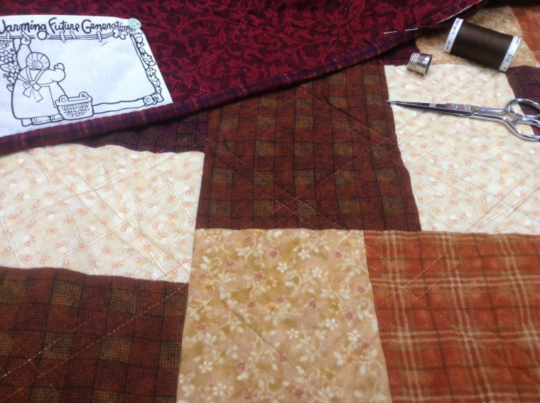 Sewing binding onto flannel quilt.